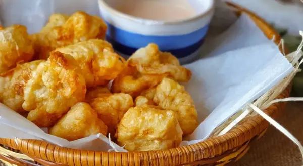 Fritos de rape crujientes y jugosos en una cesta con salsa.