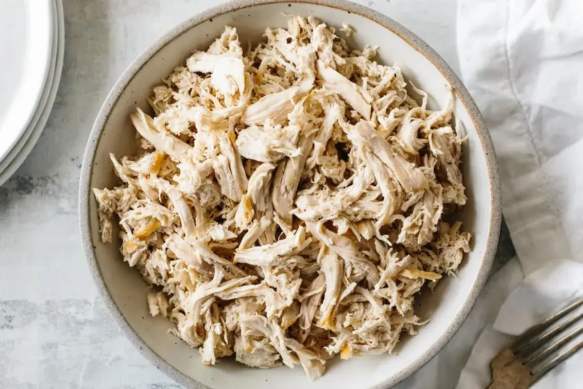 Tazón de pollo asado desmenuzado, listo para deliciosas recetas.