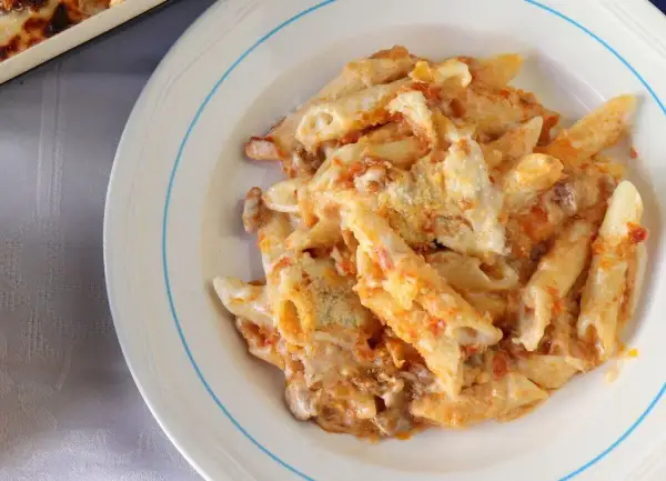 Un plato de macarrones del cardenal, cubiertos de salsa y queso, listos para disfrutar.